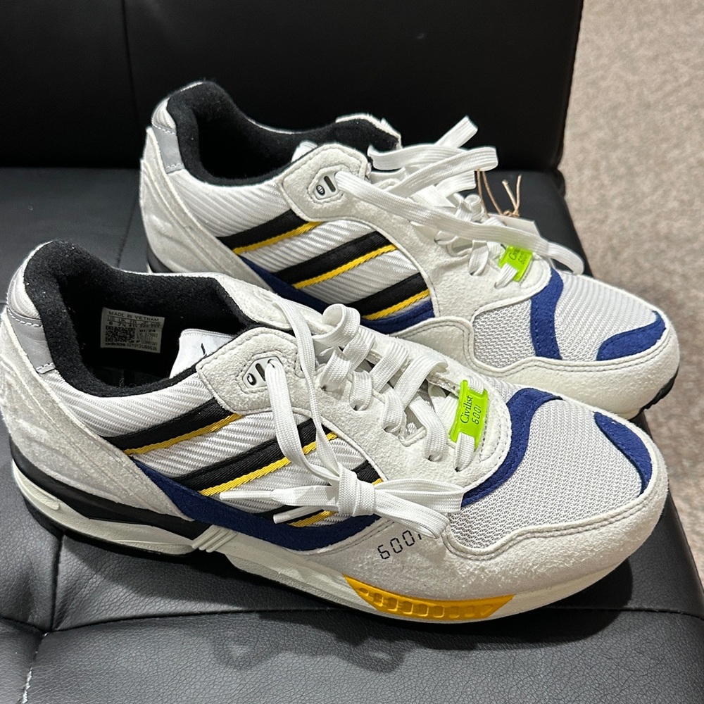 White and Blue Sneakers with Yellow Accents